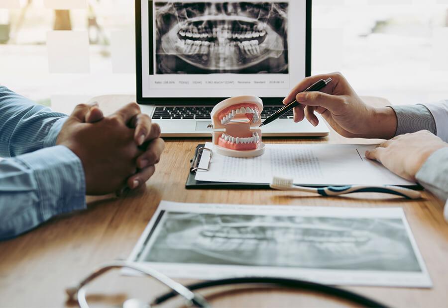 We're happy to go over options & costs for any service, regardless of your insurance Dentist and patient discussing cosmetic dental procedures and payment options
