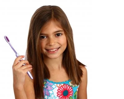 Smiling Girl with a Tooth Brush