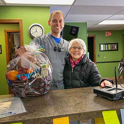 Dr. Dan Ross standing next to a patient in his southeastern WI dental clinic